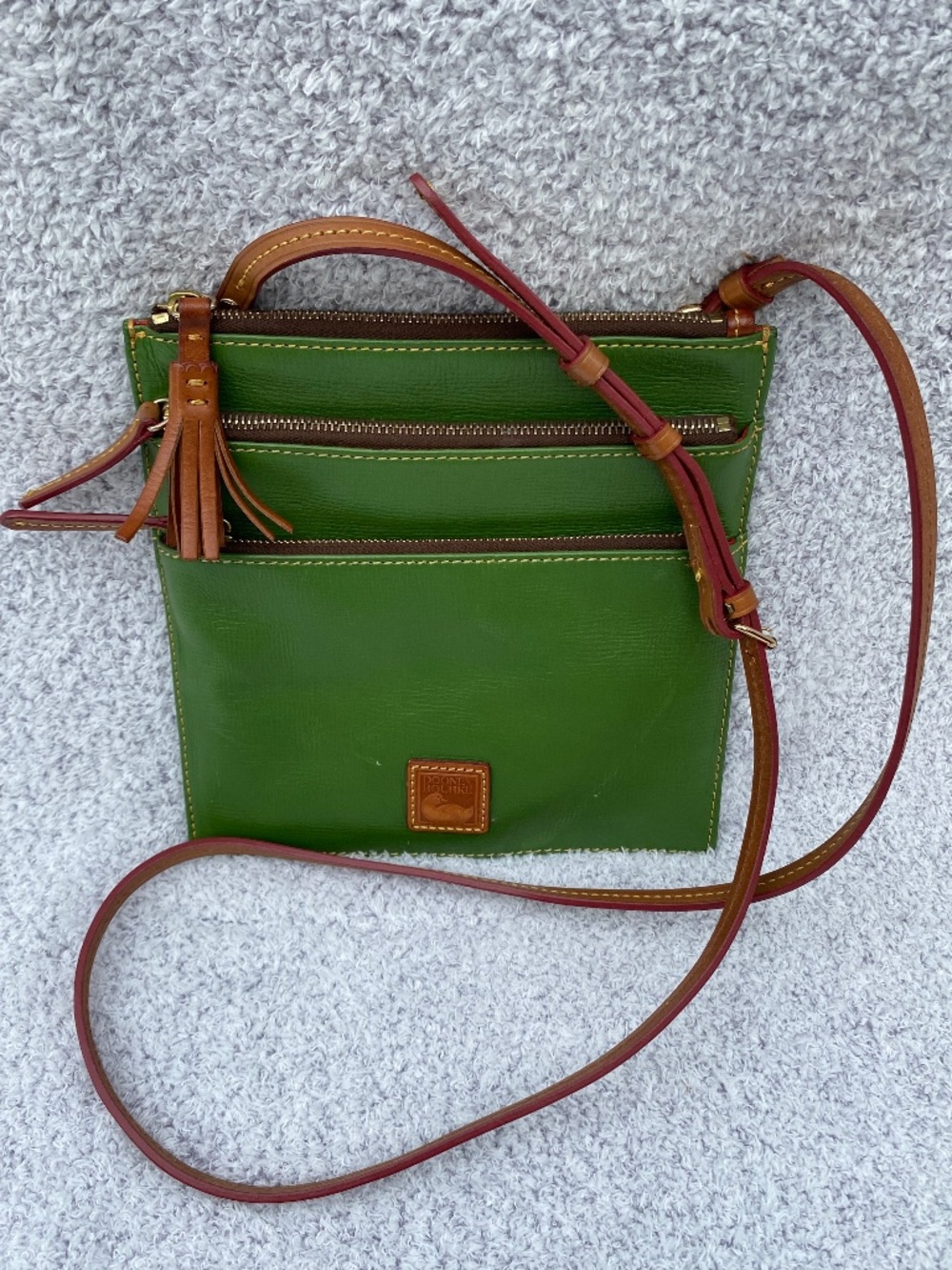 Dooney & Bourke leather crossbody purse with four compartments.